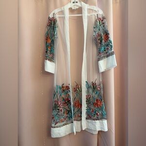 WoWo beautiful sheer overcoat/duster adorned with bright appliqué flowers.